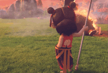 a little girl holding a pole in a field