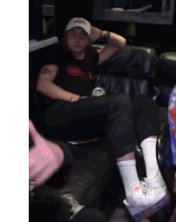 a man sitting on a couch with a can of dr pepper
