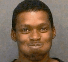 a close up of a man 's face with a slight smile on his face