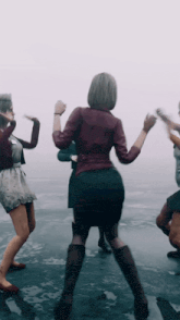 a group of women are dancing on a frozen lake