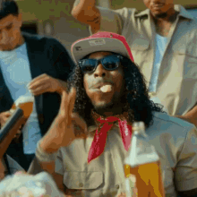 a man with a bandana around his neck that says ' snoop dogg ' on it smoking a cigarette