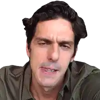 a man in a green shirt is making a silly face