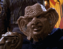 a close up of a creature with a very large head