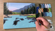 a painting of a lake is being painted by a person with the words made in animatica below it