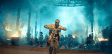 a man in a silver jacket is dancing in front of a crowd of people