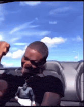 a man wearing a black shirt with a statue of a man on it