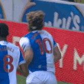 a soccer player wearing a blue and white jersey with the number 10 on the back