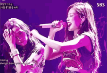 a woman singing into a microphone with a shirt that says stones