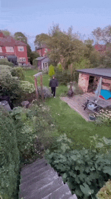 a man walking down stairs in a backyard