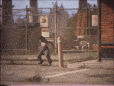 a person riding a skateboard in front of a fence with a no parking sign on it