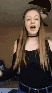 a young woman wearing a choker and a black tank top