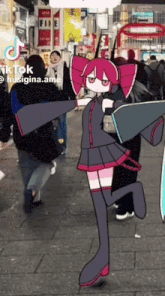 a girl in a black and pink dress is dancing on a street .