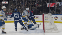 a hockey game is being played in front of a banner that says pointsbet