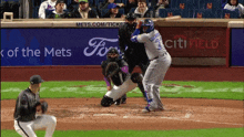 a baseball game is being played in front of a ford advertisement