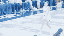 a blurred image of a female basketball player wearing a number 94 jersey