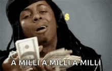 a man with dreadlocks is holding a stack of money in his hands .