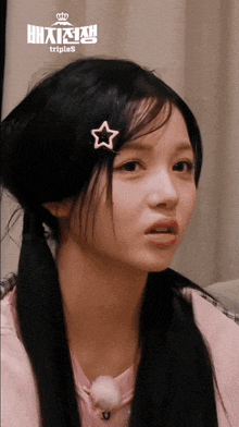 a girl with a star in her hair has triples written on the bottom