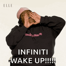 a woman wearing a balenciaga hoodie is yawning