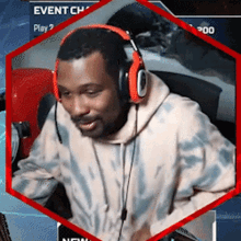a man wearing headphones is sitting in front of a computer screen that says event ch play 2