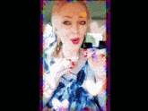 a woman in a blue dress is blowing a kiss in a car