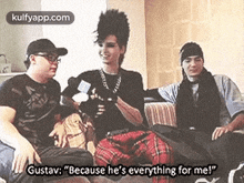 a group of people are sitting on a couch and one of them is talking to another person .