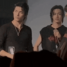 a group of young men are standing next to each other on a stage .