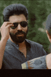 a man with a beard wearing sunglasses and a shirt that says asmp4 on it