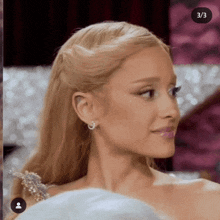 a close up of a woman 's face with blonde hair and earrings