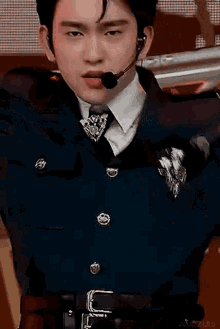 a close up of a man in a police uniform with a microphone on his ear .