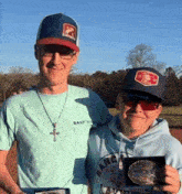 a man wearing a shirt that says ranch is standing next to a boy