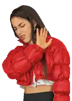 a woman in a red jacket is covering her mouth