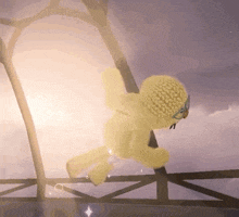 a yellow teddy bear is hanging from a rope in the air .