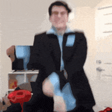 a man in a suit is standing in front of a door