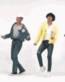 two men are dancing together in a room .