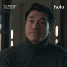 a close up of a man 's face with the words nine perfect strangers below him