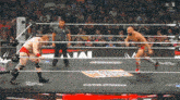 two wrestlers in a wrestling ring with the letters n on the bottom right