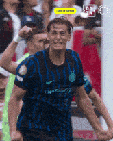 a soccer player in a blue and black jersey with the word sport on it