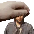 a hand is covering a man 's face in a pixel art .