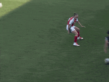 a soccer player with the number 21 on her shorts is kicking a soccer ball