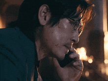 a man with blood on his face is talking on a phone