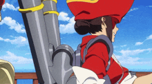 a woman in a red hat is standing next to a large pipe