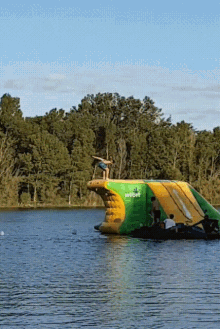 a person is jumping off a water slide which says softove on it