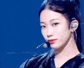 a close up of a woman 's face with a microphone behind her ear