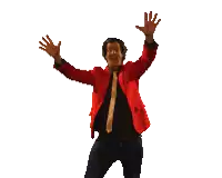 a man in a red jacket and tie is raising his arms in the air