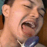 a close up of a man 's face with his tongue hanging out