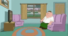 peter griffin from family guy is sitting on a couch in a living room .