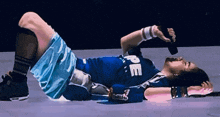a man in a blue shirt that says peace is laying on the ground