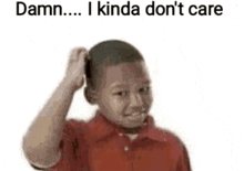 a boy in a red shirt is scratching his head with his hand .