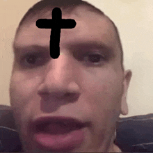 a man has a cross on his forehead