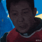 a close up of a man 's face with the word netflix on the bottom right
